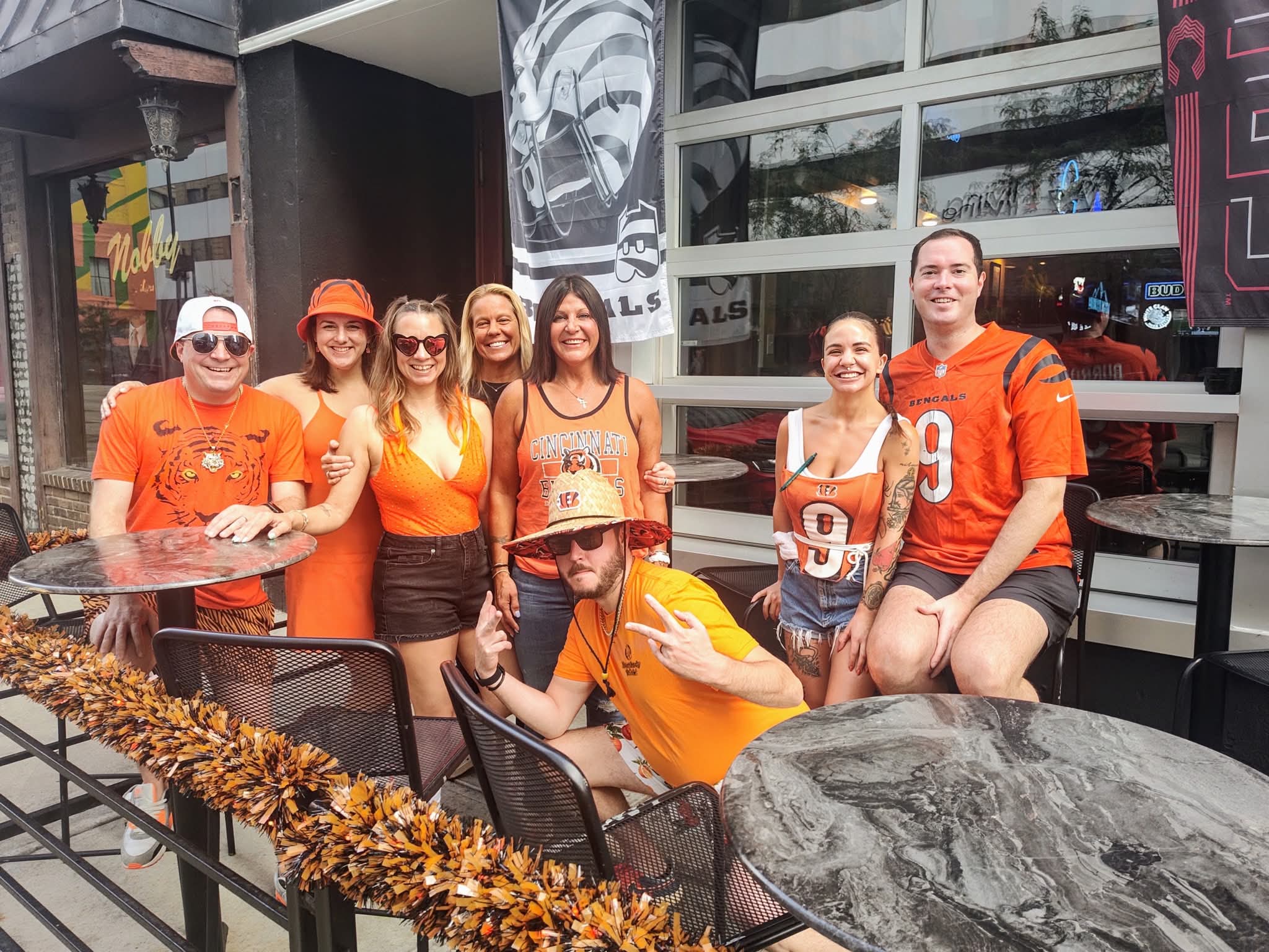A group in Bengals orange outside on the patio