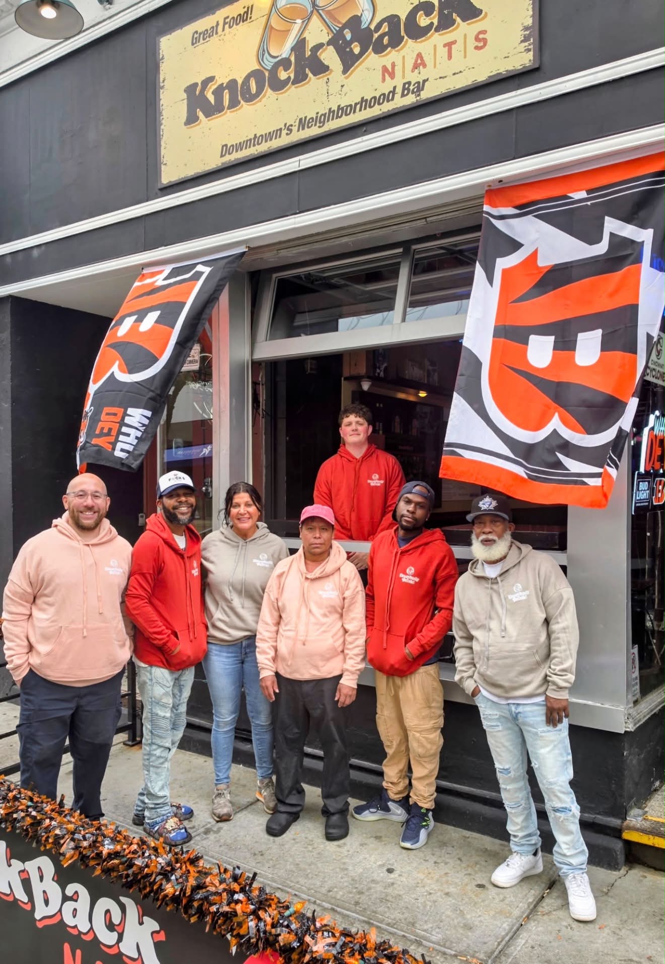 Staff in Bengals gear posing outside the storefront