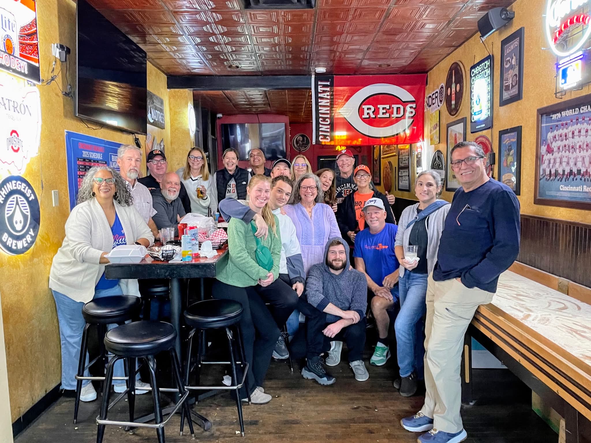 A large group photo in the shuffleboard room