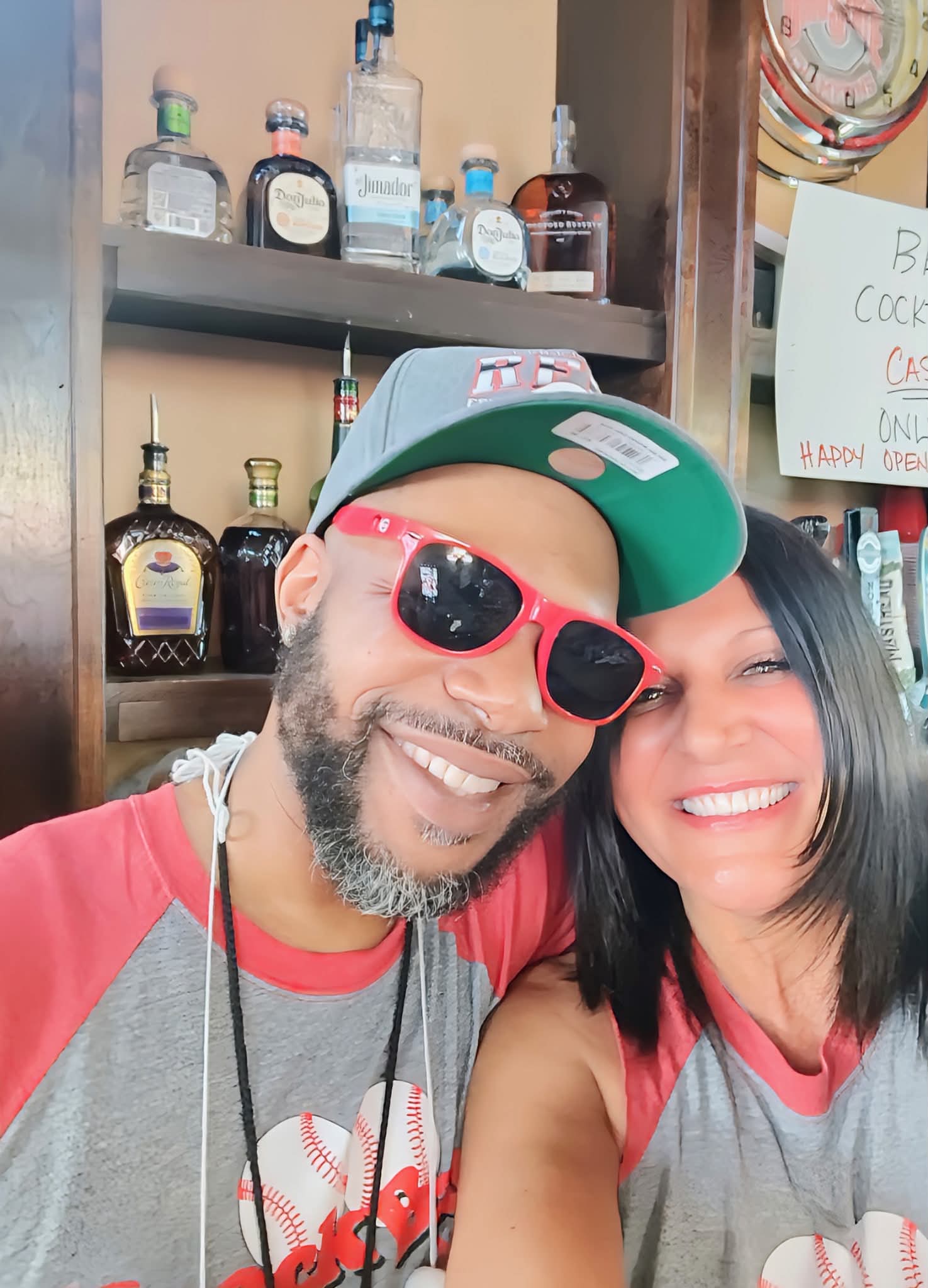 A couple smiling behind the bar