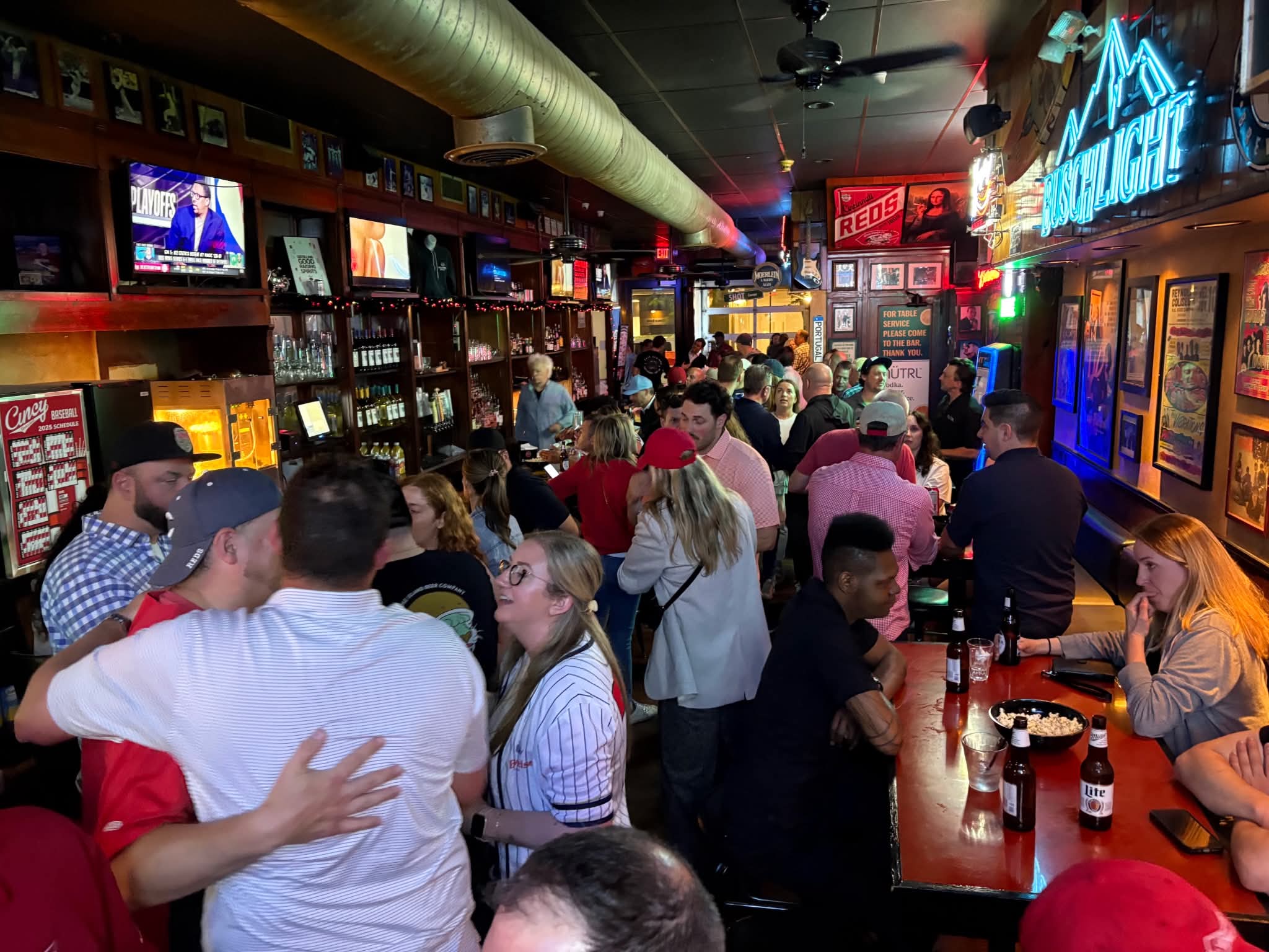 A crowded night at the bar under the Busch Light sign