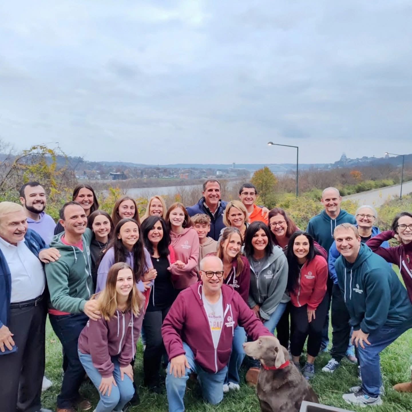 A large group photo on the hill overlooking the river