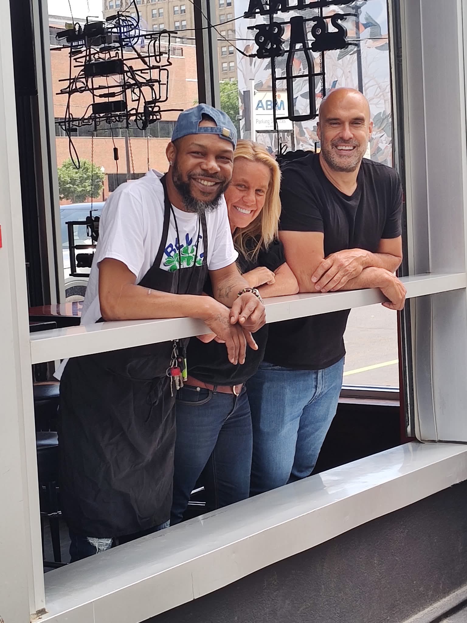 Staff leaning on the front window booth