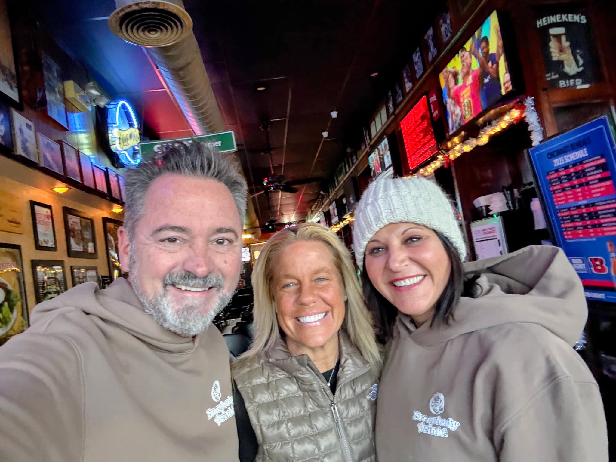 Friends in matching sweatshirts taking a selfie