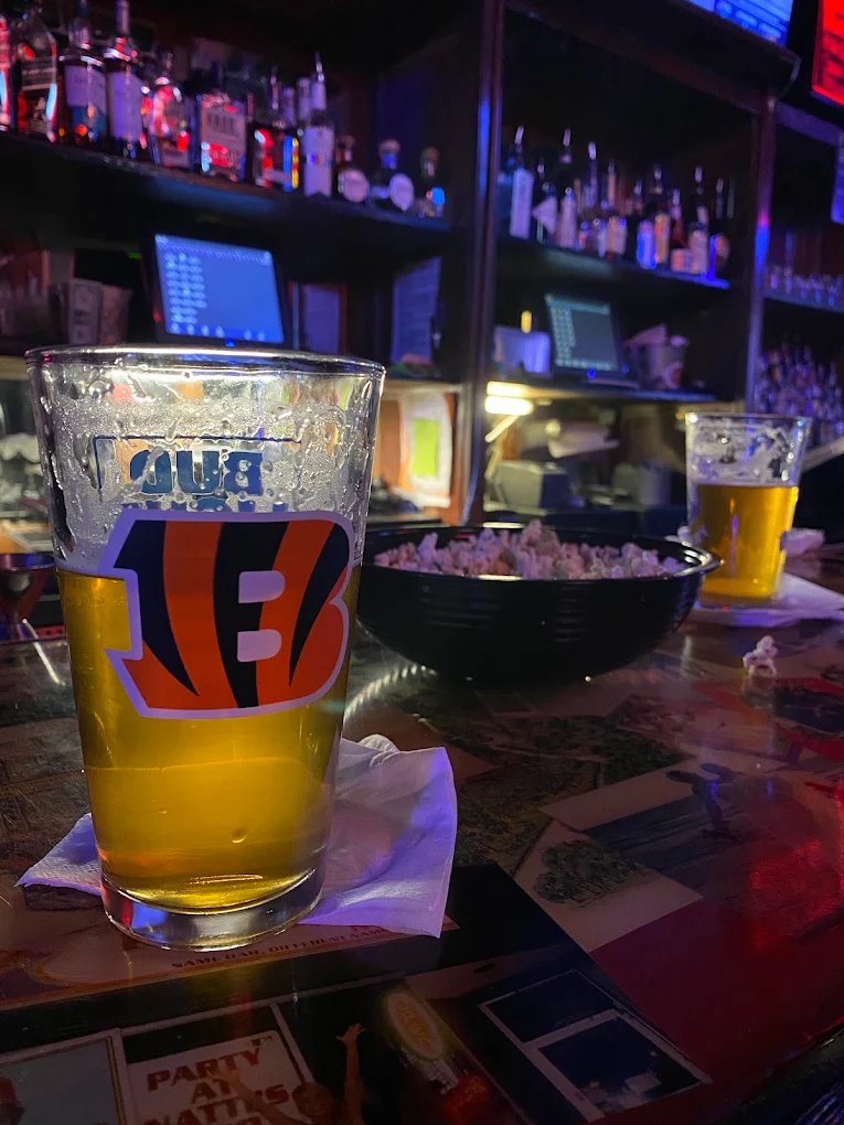 A pint of beer in a Bengals glass on the bar