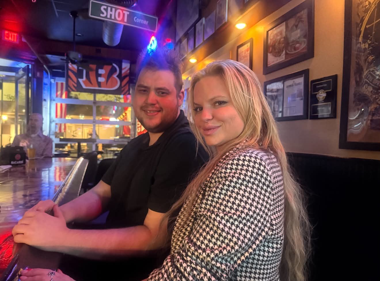 Two regulars at the bar under the Shot Corner sign