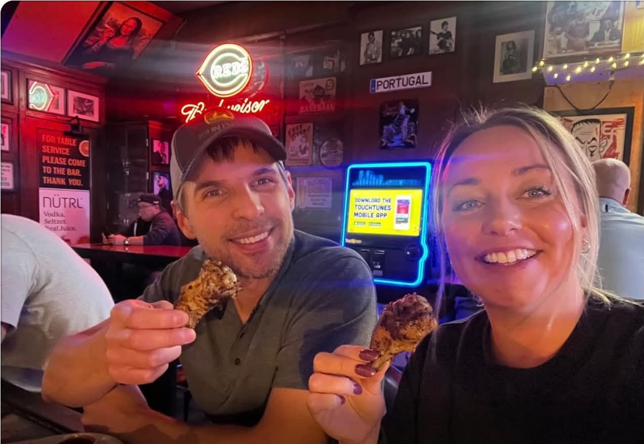 Jesse and Anna from B105 radio holding up smoked wings at Knockback Nat's